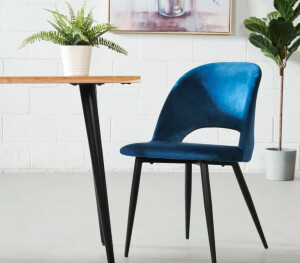 A blue velvet dining chair